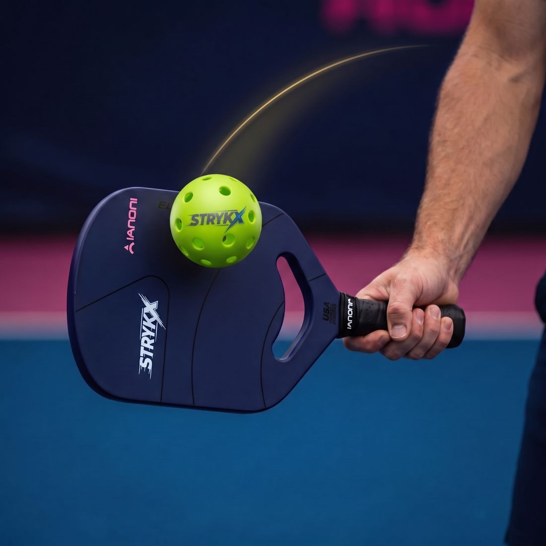 Close-up of a player's low-to-high paddle swing path on a drop shot