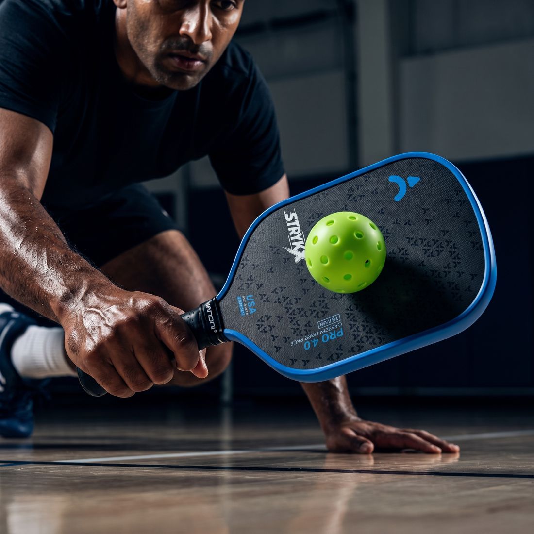 Player reacting quickly with a STRYKX Pro 4.0 paddle at the net